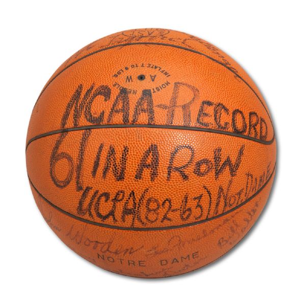 UCLA TEAM SIGNED GAME BALL FROM NCAA RECORD 61ST CONSECUTIVE WIN GAME PLAYED ON JANUARY 27, 1973 VS. NOTRE DAME (HELMS/LA84 COLLECTION)