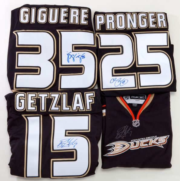 GROUP OF (4) ANAHEIM DUCKS SIGNED JERSEYS AND (5) 2007 HIGHLAND MINT PHOTO DISPLAYS