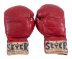 CASSIUS CLAY’S FIGHT-WORN GLOVES FROM 1962 BOUT VS. ARCHIE MOORE