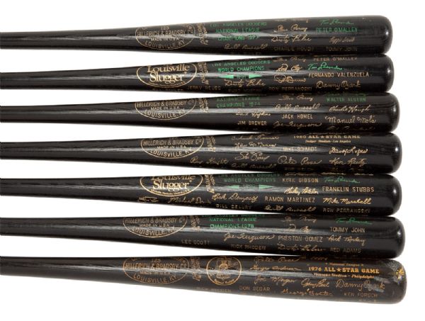 BILL RUSSELLS COLLECTION OF 7 LOUISVILLE SLUGGER COMMEMORATIVE BLACK BATS - 1981 & 1988 WORLD CHAMPIONS; 1974, 1977, & 1978 NATIONAL LEAGUE CHAMPIONS; AND 1976 & 1980 ALL-STAR GAME (RUSSELL LOA)