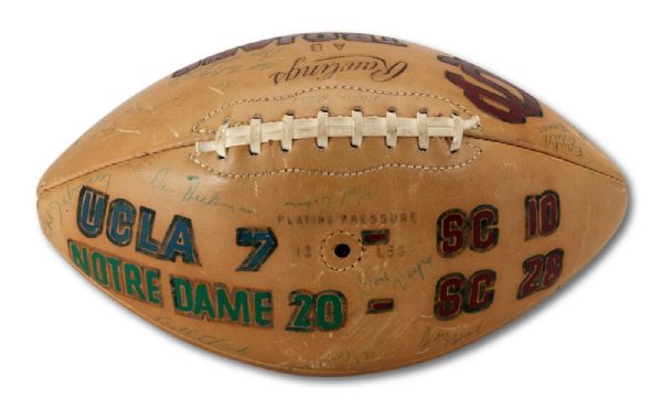 1956 USC TROJANS TEAM SIGNED FOOTBALL WITH UCLA AND NOTRE DAME RIVALRY VICTORY EMBELLISHMENTS (NSM COLLECTION)