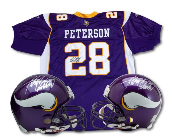 ADRIAN PETERSON PAIR OF SIGNED MINNESOTA VIKINGS PROFESSIONAL GAME MODEL HELMETS AND SIGNED AUTHENTIC VIKINGS JERSEY (ZWEIGLE COLLECTION)