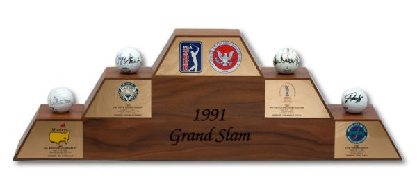 UNIQUE 1991 GRAND SLAM OF GOLF MINI WOODEN DISPLAY WITH ALL FOUR OFFICIAL MAJOR CHAMPIONSHIP BALLS SIGNED BY EACH CHAMPION (ZWEIGLE LOA)