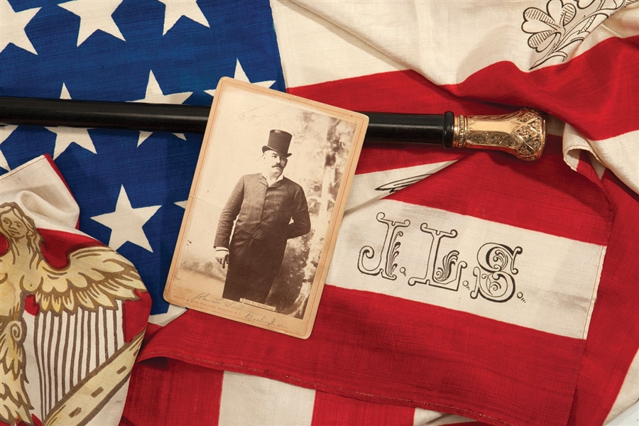 FINE 1880S JOHN L. SULLIVAN PRESENTATIONAL WALKING STICK, SILK FLAG, AND CABINET PHOTOGRAPH